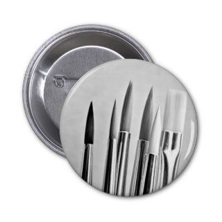 Black and white paint brushes design pin