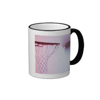 Blurred view of basketball going into hoop coffee mugs