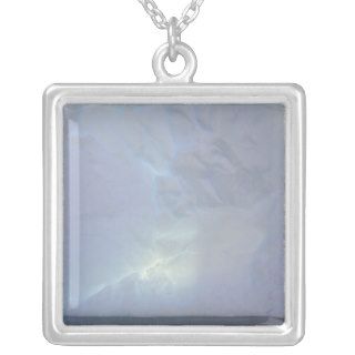 Thin backlit and almost transluscent ice wall of pendants