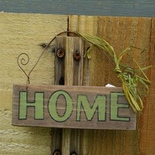 garden hanging signs by boxwood