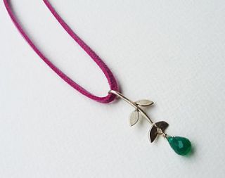 handmade leaf gemstone pendant on suede by blossoming branch