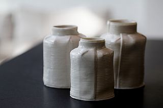 set of three porcelain white striped jars by clare hartley