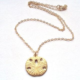 gold sand dollar necklace by a box for my treasure