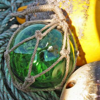 green glass float by buy the sea