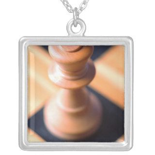 King chess piece on chessboard custom jewelry