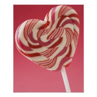 Red and white heart shaped lollipop against pink b posters